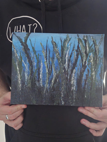 Person holding a small abstract painting with blue and black brush strokes.
