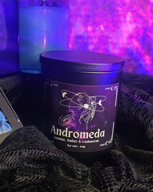 Candle jar labeled 'Andromeda' with a dark background