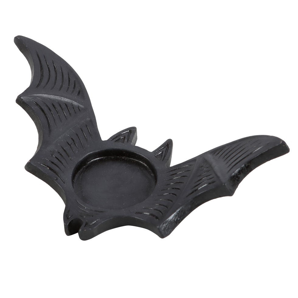 Black bat-shaped candle holder on a white background