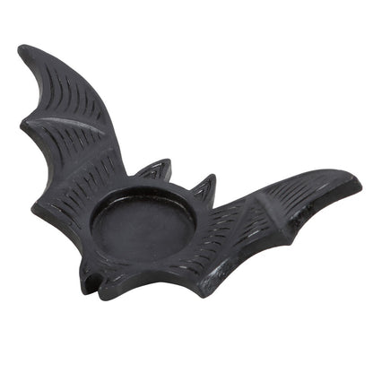 Black bat-shaped candle holder on a white background