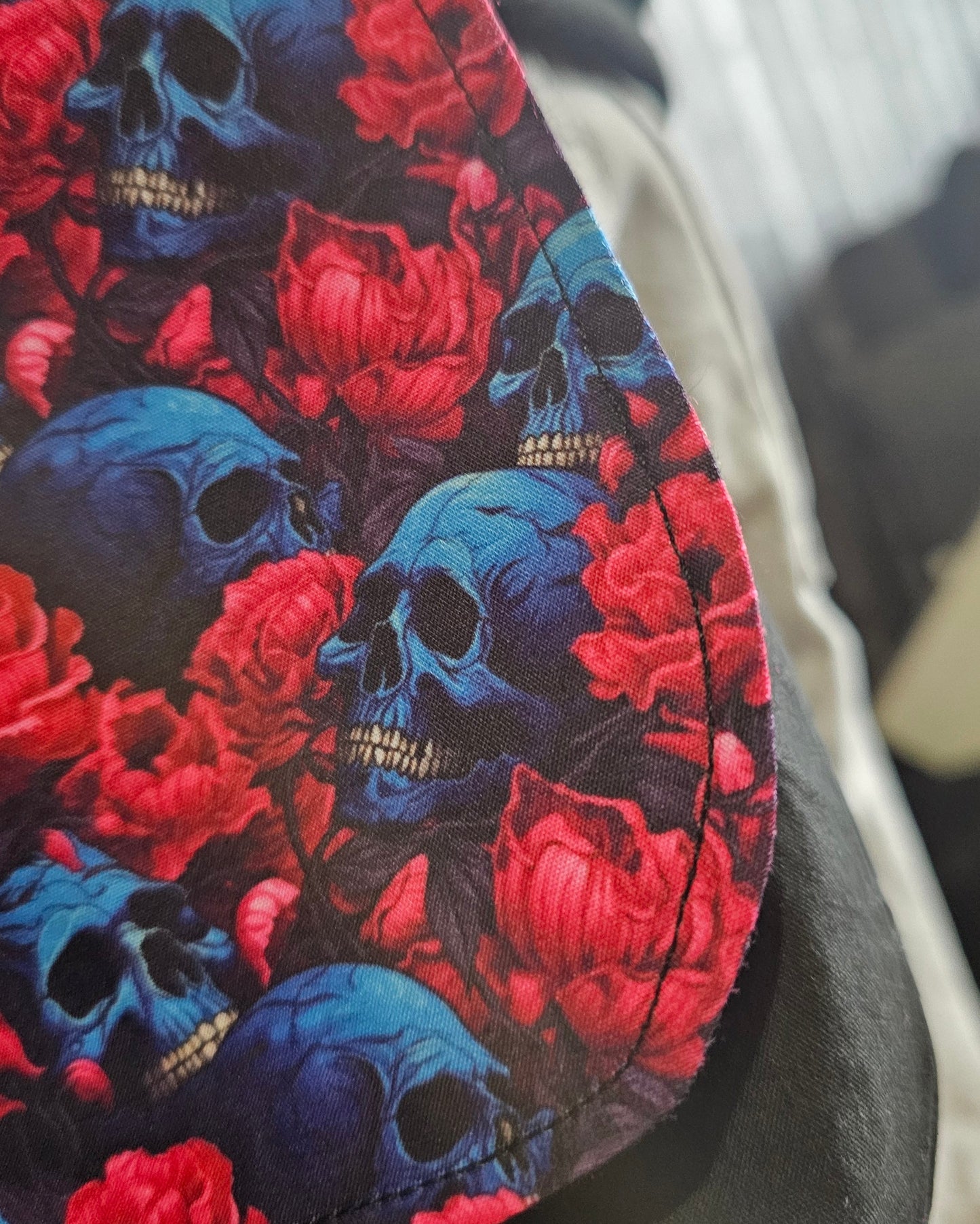 Close up of stitching on Floral and skull patterned bag 