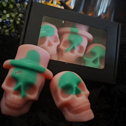 A set of skull-shaped wax melts with a greenish tint, displayed in a black box, with the product name 'Ostara' mentioned.