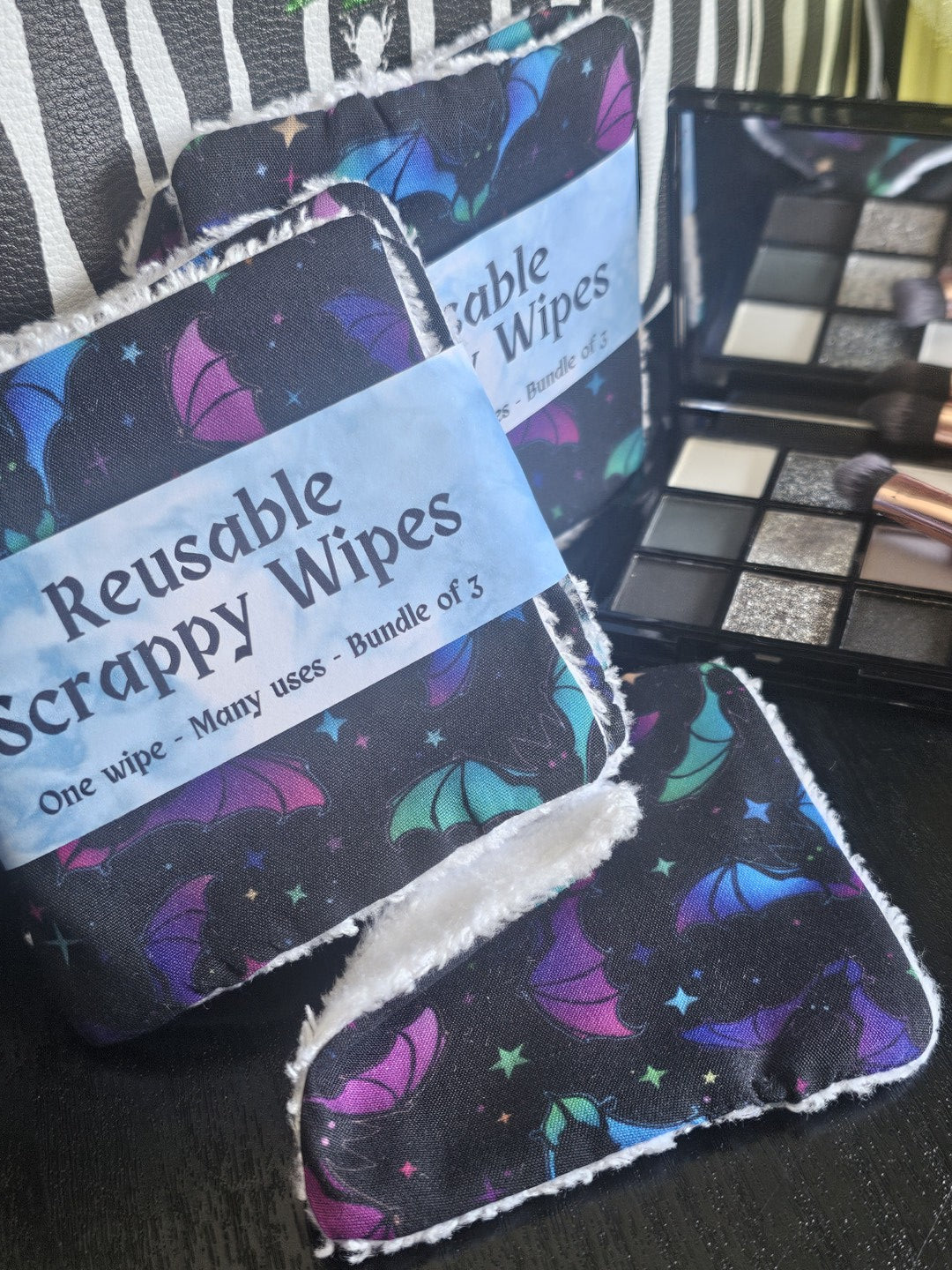 Reusable wipes with a colorful design on a black surface