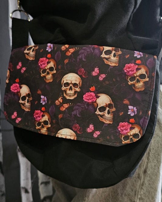 Floral skull patterned bag worn over shoulder 