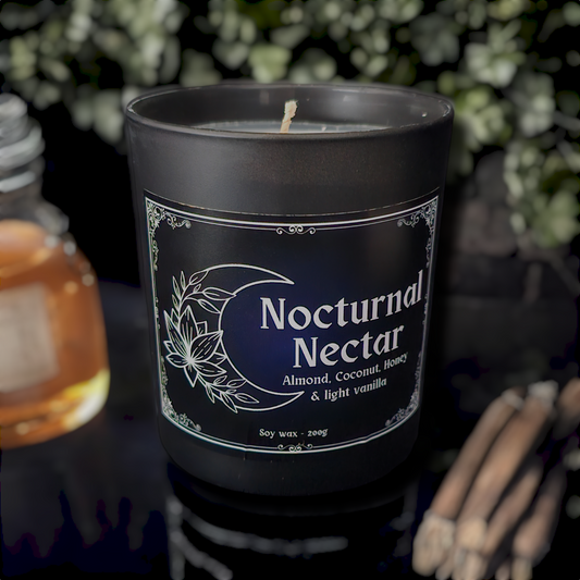 A black glass candle container with a white bamboo lid, labeled 'Nocturnal Nectar', with illustrations of a moon and flowers.