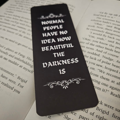 Black bookmark with white text on a book page