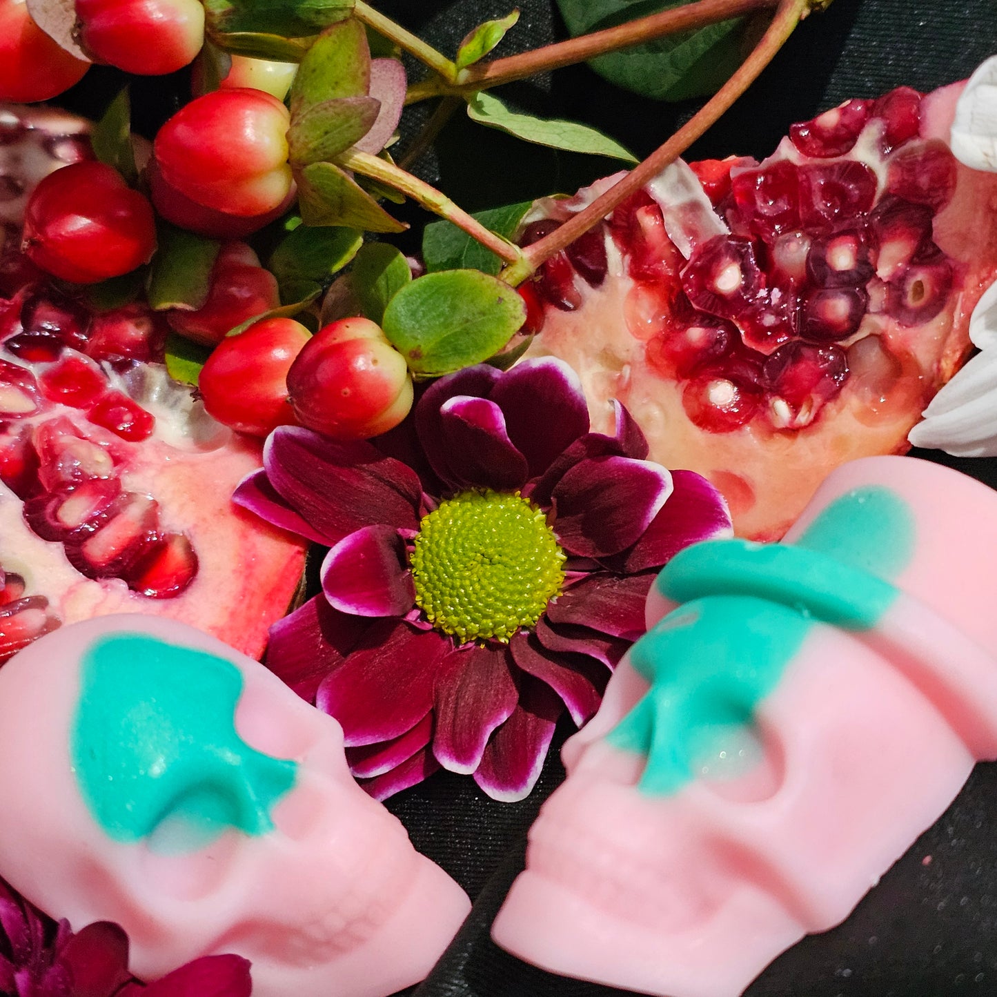 A clo9se up of the pink and green skull shapes of the Ostara wax melts 