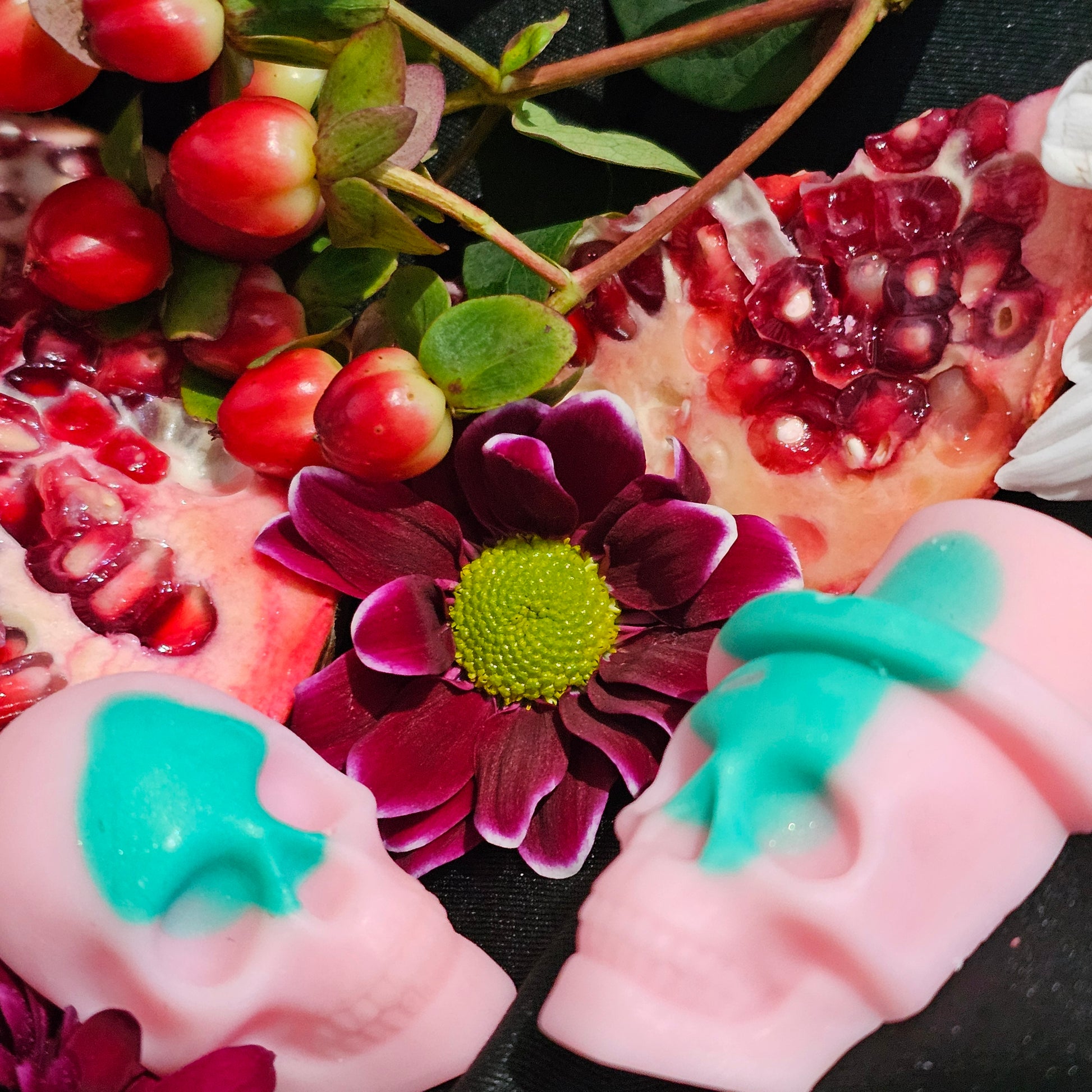 A clo9se up of the pink and green skull shapes of the Ostara wax melts 
