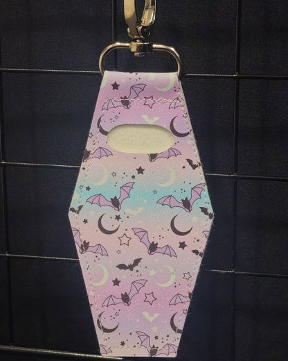 Coffin-shaped lip gloss holder keychain in Pastel Bat and Moon  print leatherette with stainless steel lobster clasp.