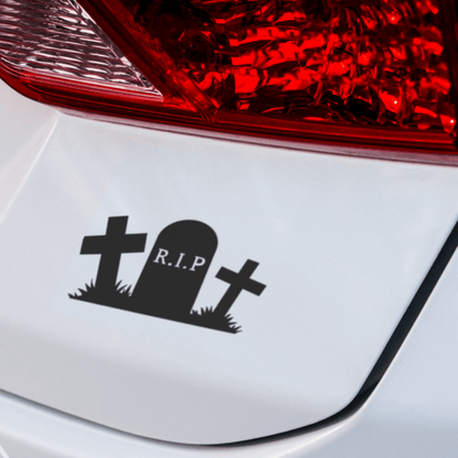 A black vinyl decal in the shape of a tombstone and Crosses  with the text 'R.I.P' placed on a car's rear window, featuring a simplistic design.