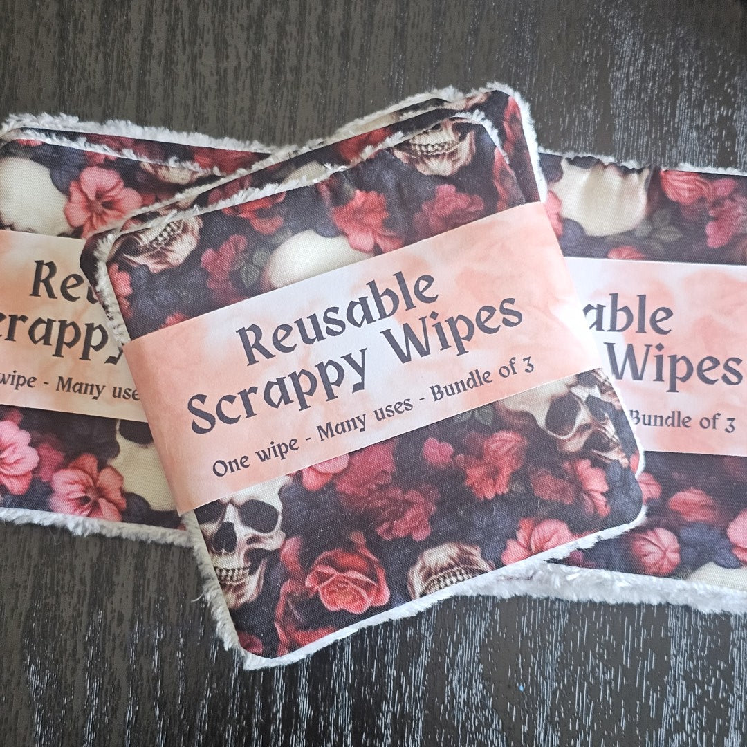 Reusable scrappy wipes with floral  and skull pattern on a dark surface