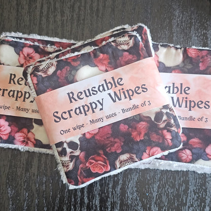 Reusable scrappy wipes with floral  and skull pattern on a dark surface