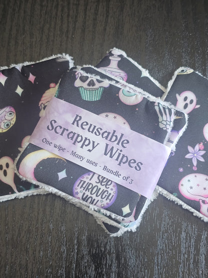 Reusable scrappy wipes with a visible brand label on a dark wooden surface