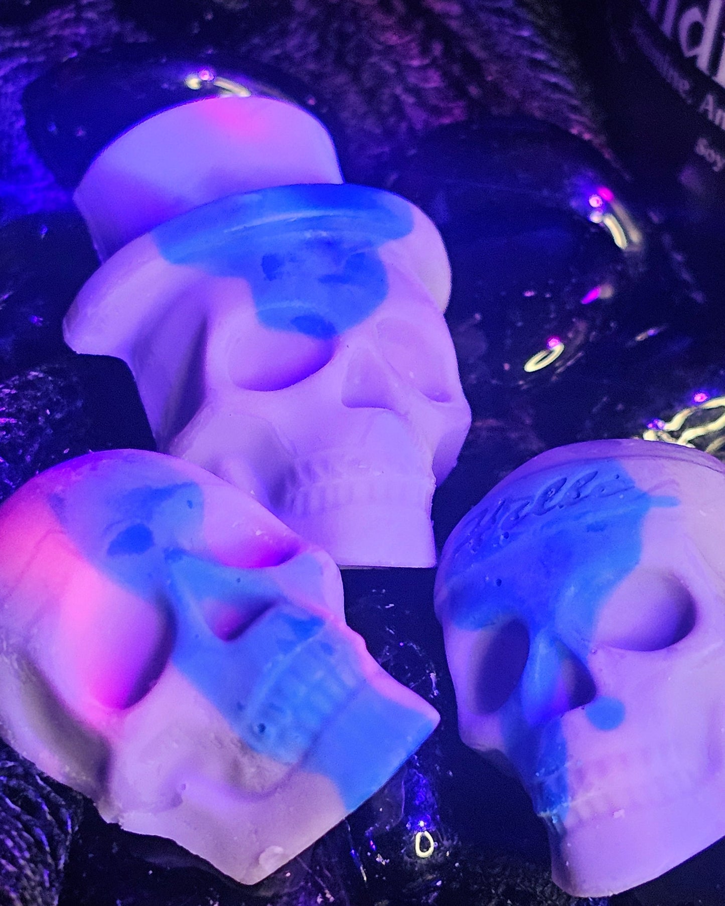 Skull-shaped objects with glowing blue accents on a dark background