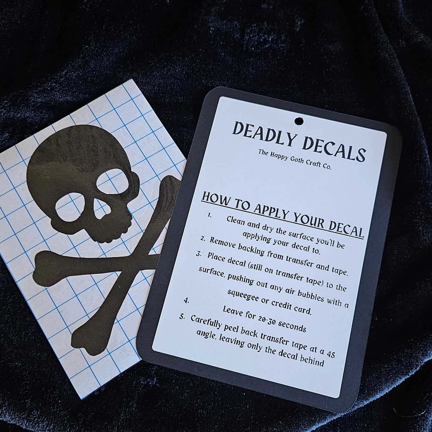 A vinyl decal with a skull and crossbones design, accompanied by application instructions.