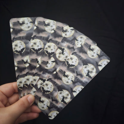 A fan of 5 bookmarks, with a bat and moon pattern 