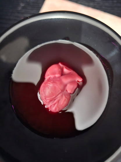A heart shaped wax melt, melting in a burner
