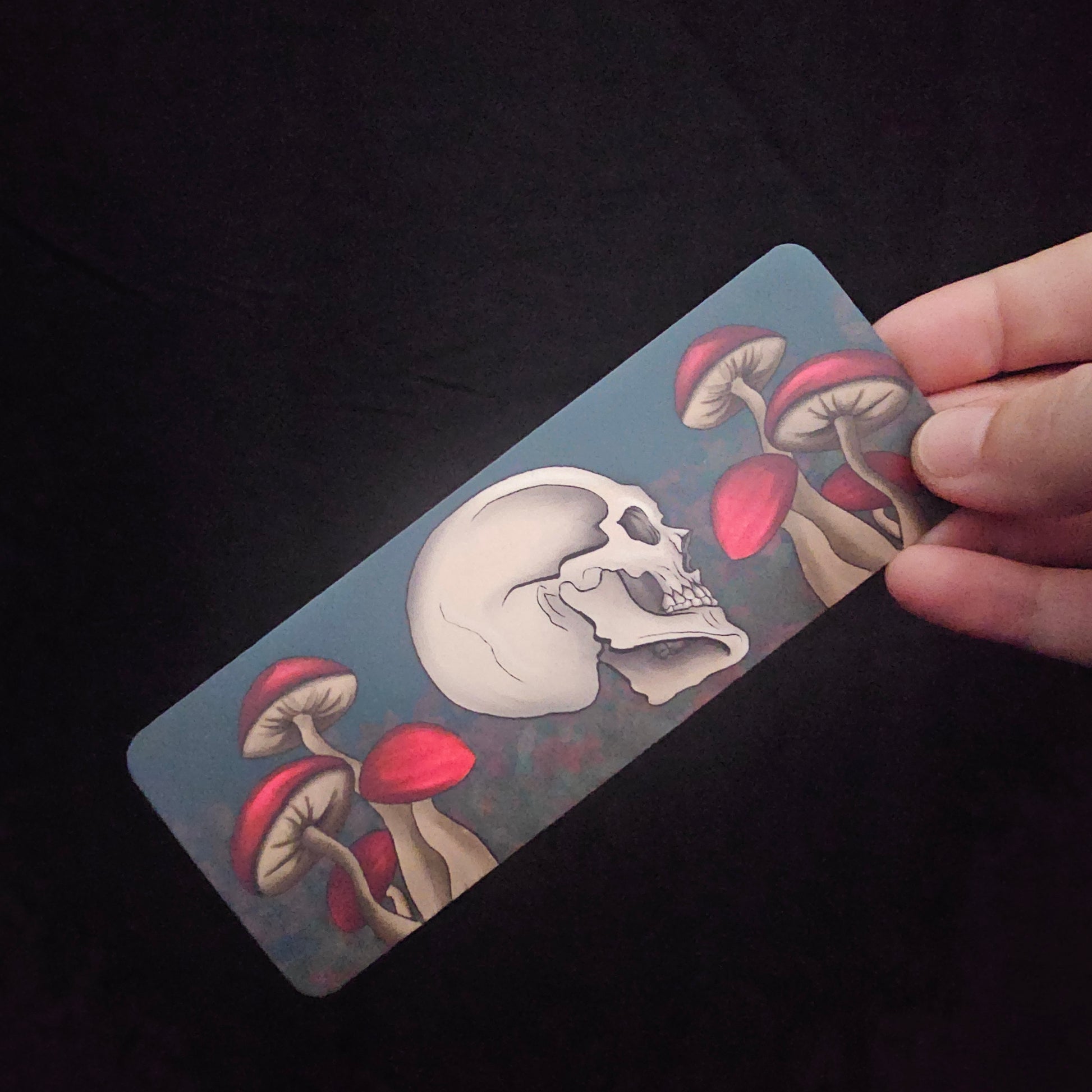 Bookmark with skull and red capped mushrooms 